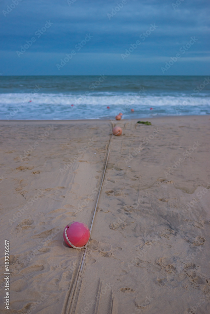 Red round buoys lie on the beach tied with a rope. Seaview, Beach safety Red round buoys lie on the beach tied with a rope. Seaview, Beach safety