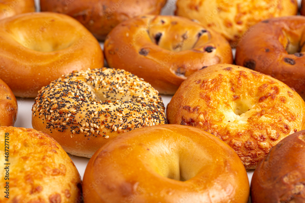 A Variety of Different Bagel Flavors on a White Background A Variety of Different Bagel Flavors on a White Background