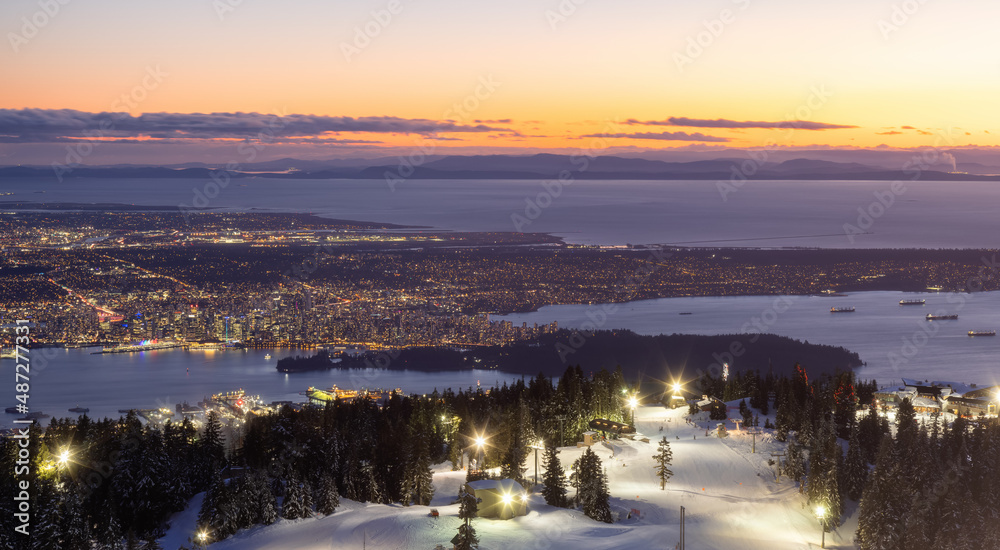 View of Top of Grouse Mountain Ski Resort with the City in the background. North Vancouver, British Columbia, Canada. Sunset Sky