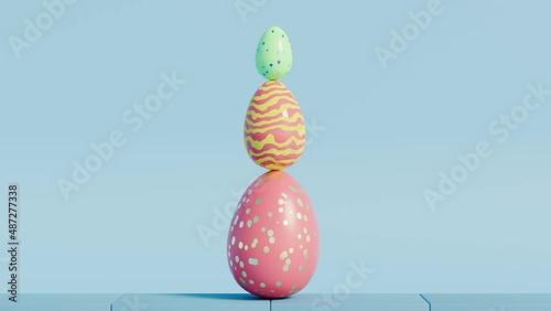 Looped satisfying video of colourful Easter eggs rolling and balancing on blue background. 3d render CGI spring animation