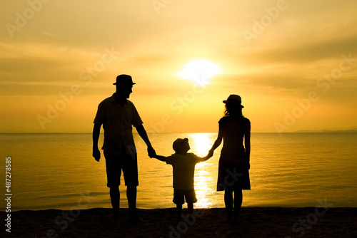 A happy family in nature by the sea on a trip silhouette © Kostia