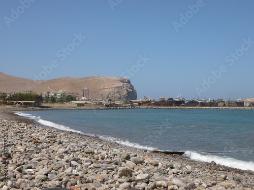 Photograph taken on a sunny day around Arica City at Chili, showing the architecture and colours of this historical place. Streets, beach, cemetery, desert, houses, square. photo