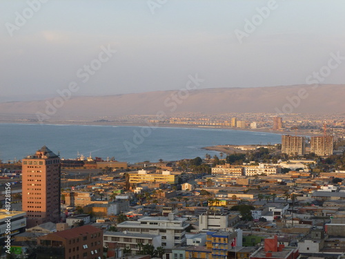 Photograph taken on a sunny day around Arica City at Chili, showing the architecture and colours of this historical place. Streets, beach, cemetery, desert, houses, square.