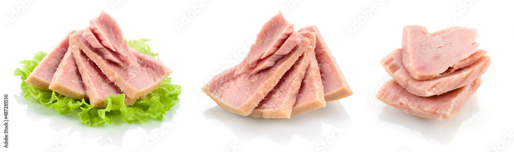 Tuna fish isolated. Canned tuna on green salad leaf. Tuna can on white background. Collection.