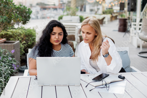 Two women discuss a common project during their lunch break. Business, collaboration. © Sviatlana