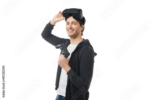Delighted gamer with gamepad and in VR headset