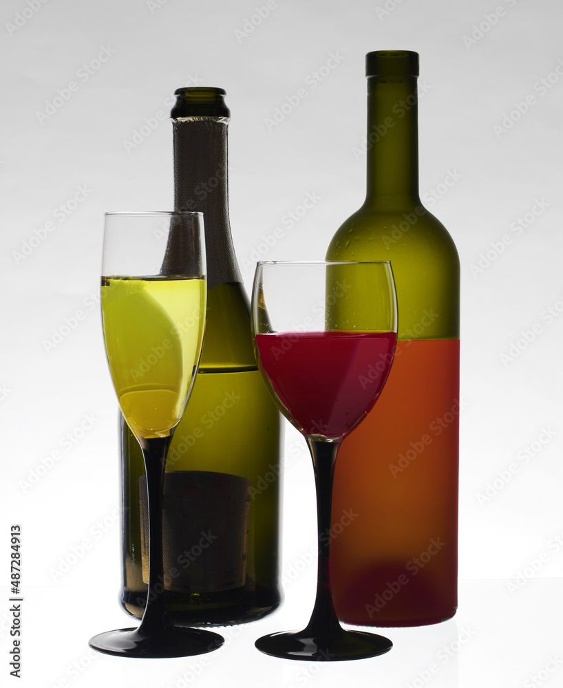 Two glasses of white and red wine and two bottles. Two glasses of white and red wine and two bottles.