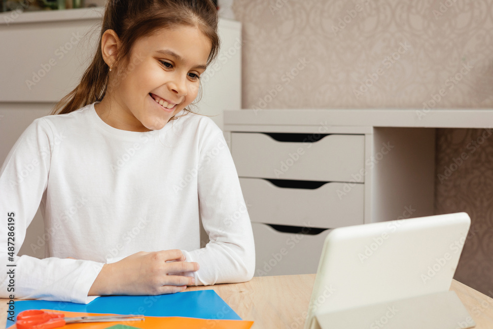 The girl is sitting at the table and is undergoing online trening. The girl is sitting at the table and is undergoing online trening.