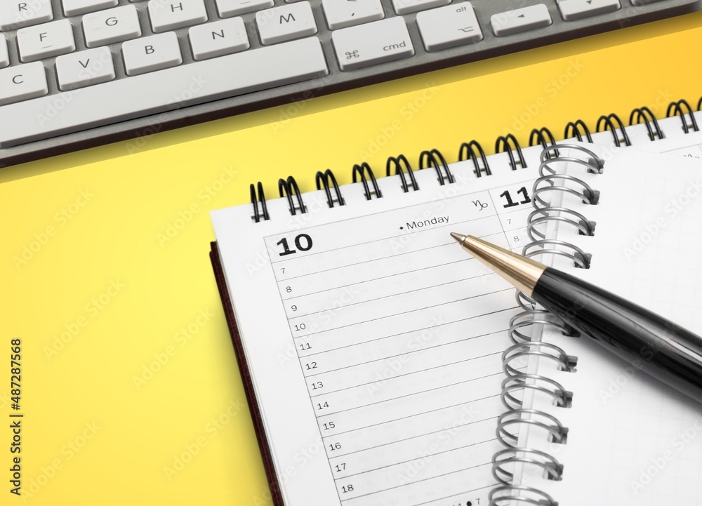 Note pad calendar with keyboard computer on desk Note pad calendar with keyboard computer on desk