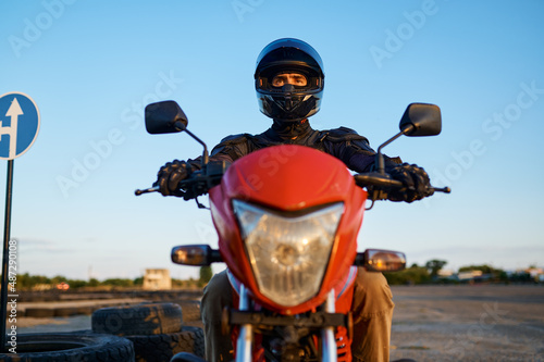 Fototapeta Naklejka Na Ścianę i Meble -  Man on motorbike, front view, motorcycle school