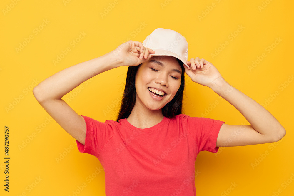 cheerful woman of asian appearance in a cap posing cheerful woman of asian appearance in a cap posing