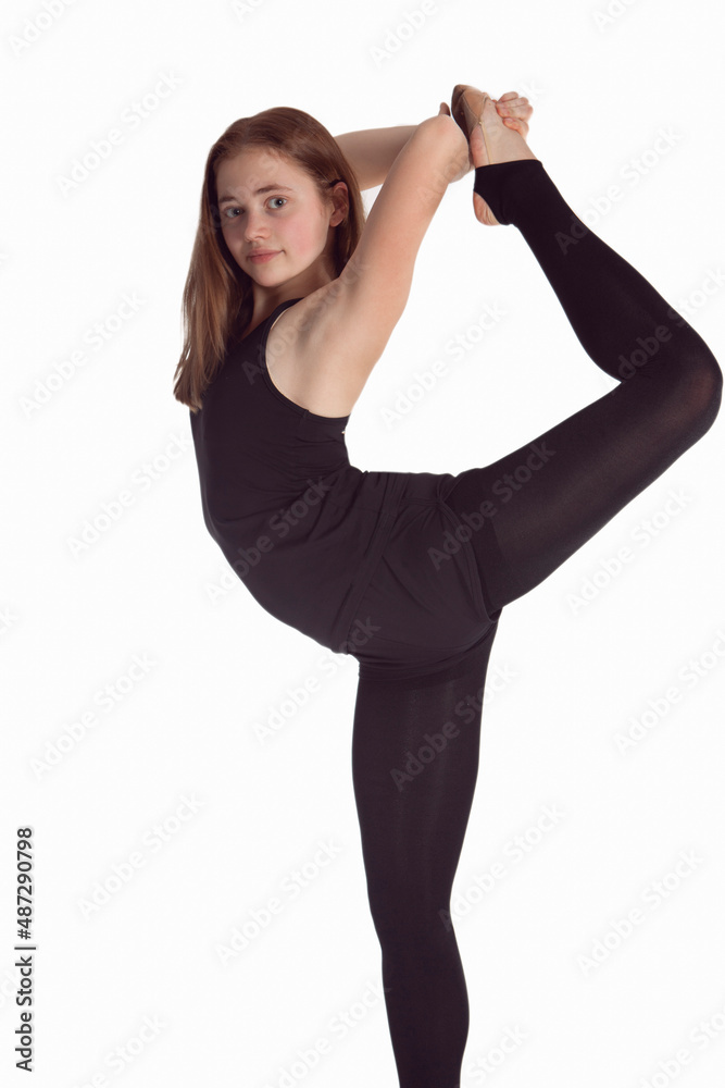 Sport Concepts. Portrait of  Caucasian Rhythmic Gymnast Sportswoman In Training Outfit During Her Legs Split Muscles Stretching  Against White.