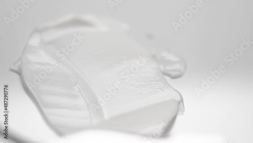 Wallpaper Mural Spreading soft cream over white background with small metal spatula macro view. Texture of natural skincare cosmetic product Torontodigital.ca