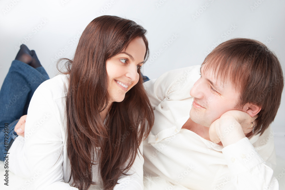 Modern Family Concepts. Caucasian Loving Happy Couple Posing With Heads Turned to Each Other Smiling With Positive Emotions On White Background. Modern Family Concepts. Caucasian Loving Happy Couple Posing With Heads Turned to Each Other Smiling With Positive Emotions On White Background.