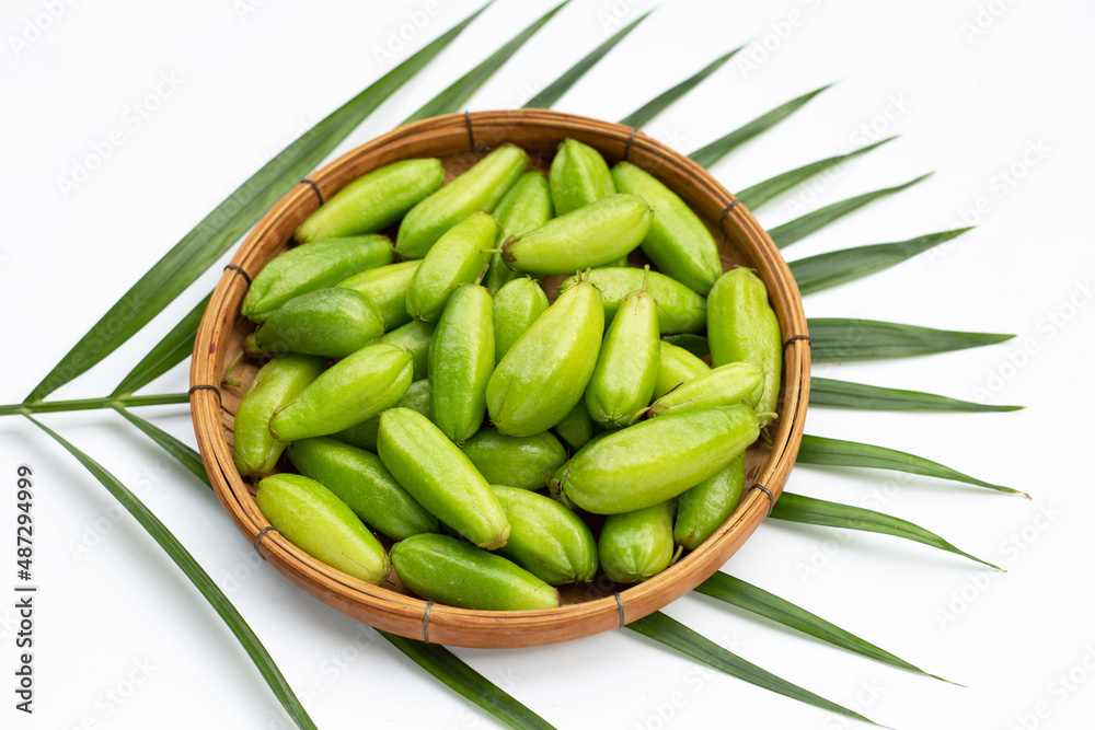 Bilimbi fruit in bamboo basket on white background. Bilimbi fruit in bamboo basket on white background.