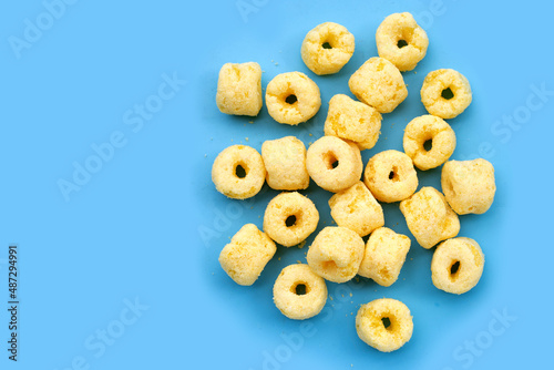 Roller corn snack on blue background.