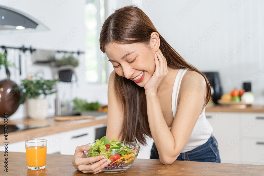 Diet, Dieting, pretty slim asian young woman or girl smiling, looking at mix vegetables, green salad bowl, eat vegetarian food is low fat good healthy. Nutritionist weight loss for health person.