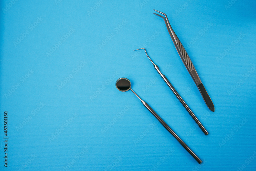 Dentist office with tools for teeth care at blue background top view close up macro. Dentist Professional tools medical equipment. Dental Care conceptual image background. Basic dentist tools.