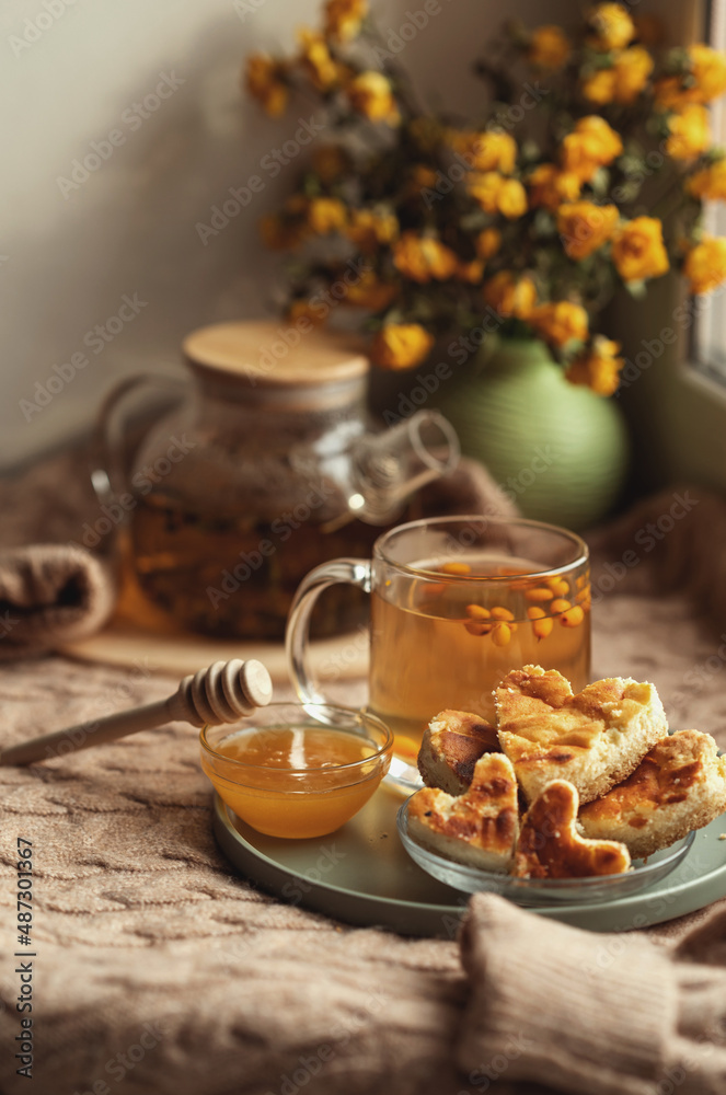 Fototapeta premium cup of tea and cookies. composition with a glass teapot and glasses filled with tea with lemon
