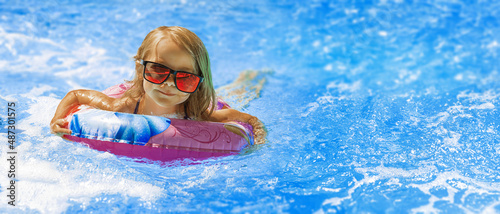 Canvas Print beach vacation in summer by the sea -  Child in swimming pool on ring toy