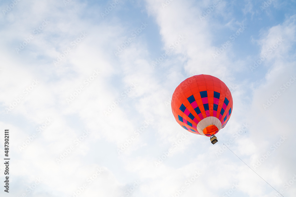 Fototapeta premium Blue air balloon flying in the clear blue sky