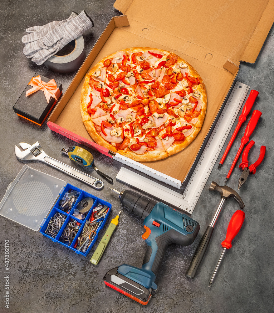 Pizza in a cardboard box photo for menu. Delivery hot pizza during the pandemic. Have a snack in the workshop while working