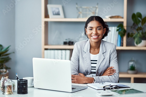 My ambition doesnt have an off switch. Portrait of a young businesswoman working at her desk in a modern office. photo