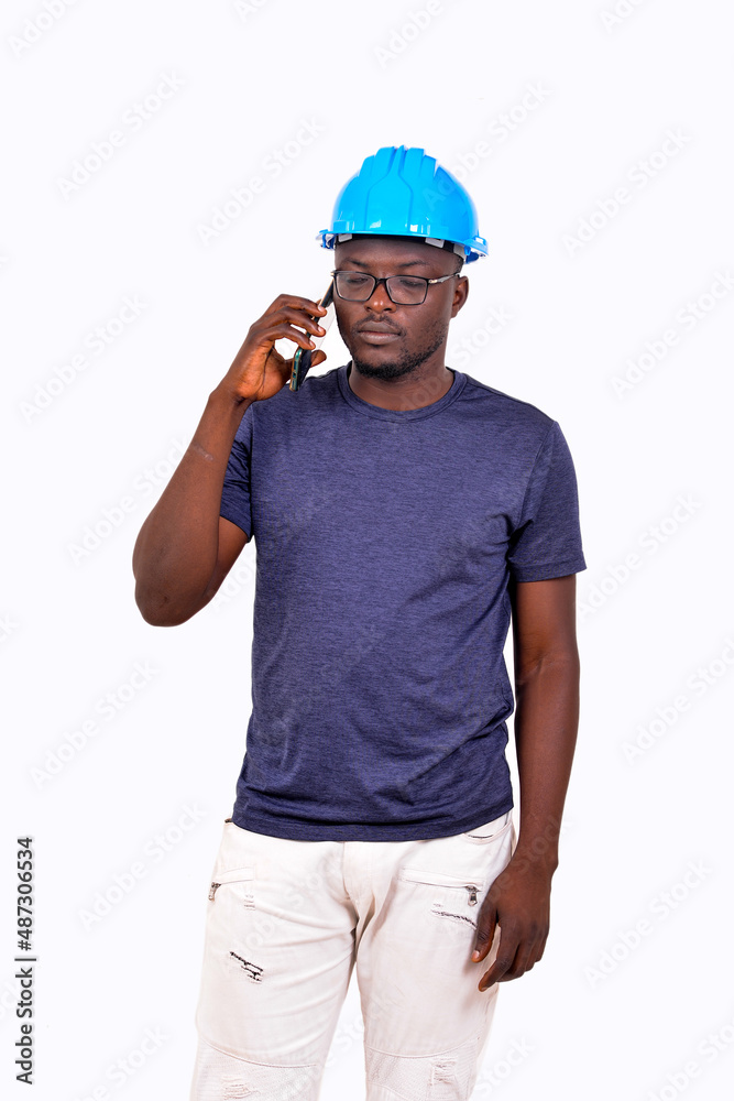 young man engineer talking on mobile phone.