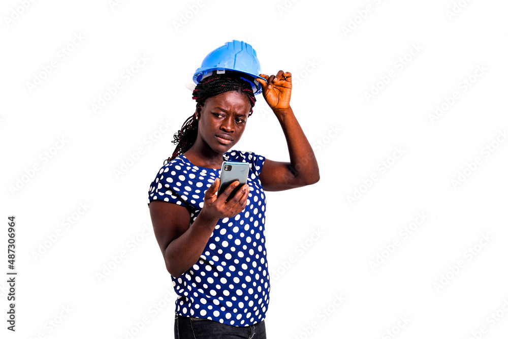 portrait of a beautiful female engineer with pensive cellphone. portrait of a beautiful female engineer with pensive cellphone.