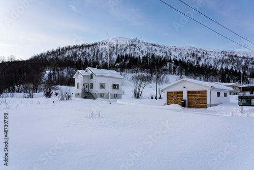 Cabins on the island with snow mountain, in Tromsø Norway © Olivier Wong