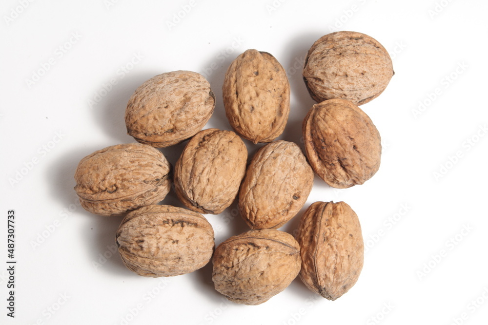 a handful of walnuts on a white background a handful of walnuts on a white background