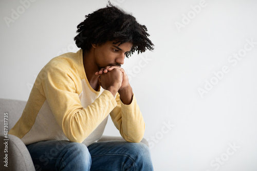 Contemplation Concept. Closeup Shot Of Thoughtful Young Black Man Sitting In Armchair