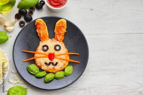 Photography Mini easter bunny pizza on plate with white wood background