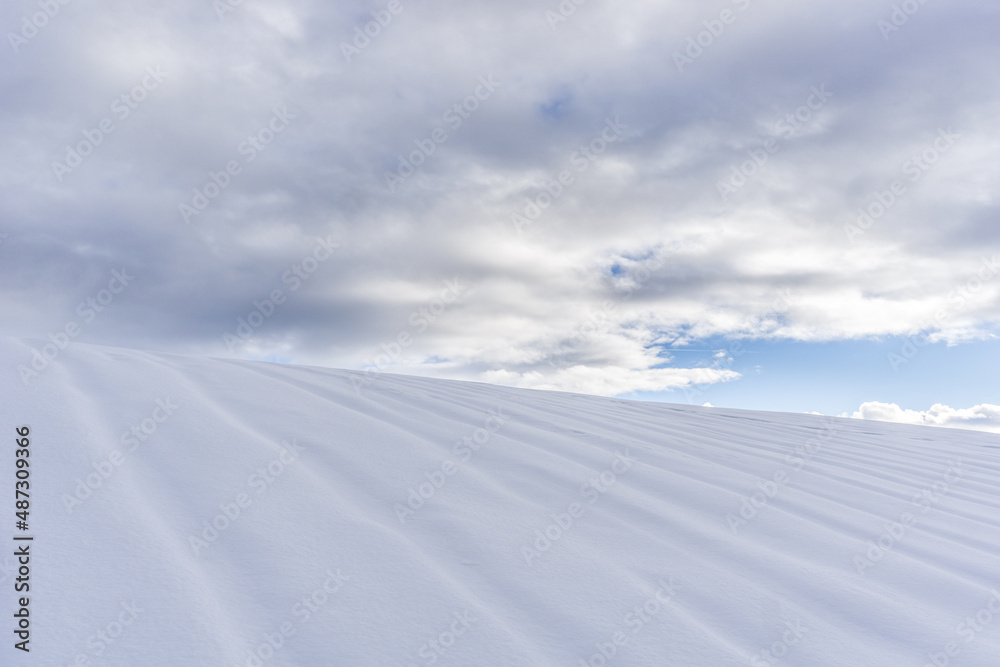 abstract picture of a hill full of snow with cloudy sky 