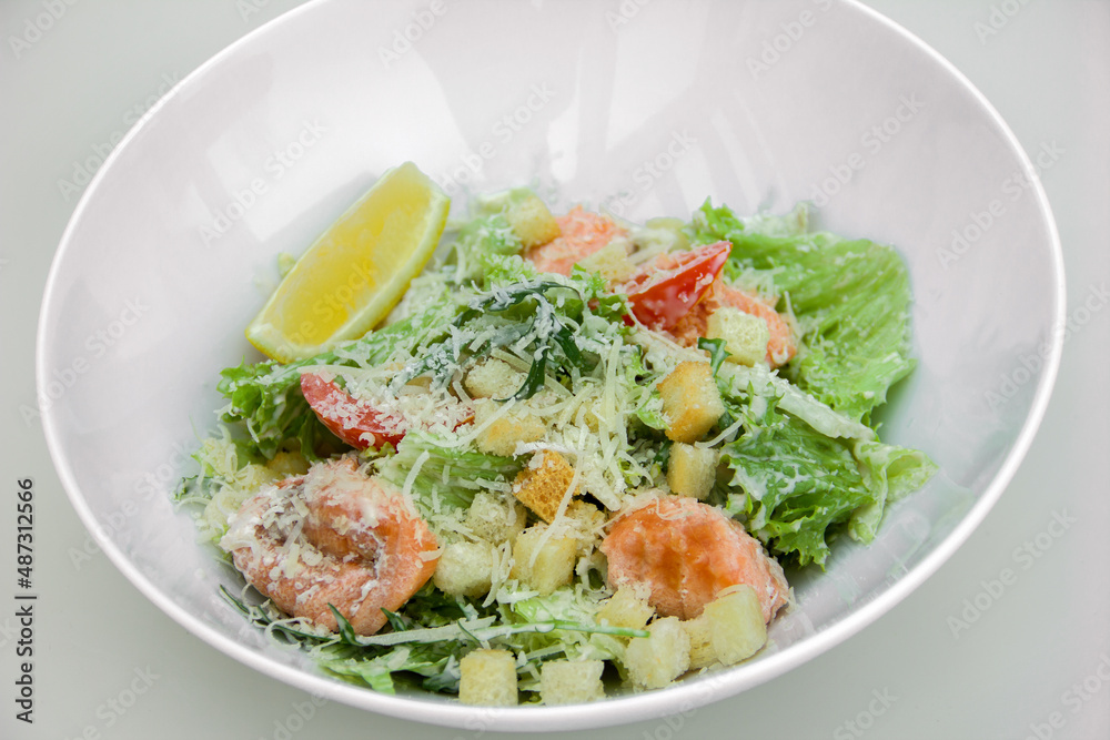 light dietary salad of leaves, red fish fillet, grated cheese croutons and dressing. The theme of proper and healthy nutrition, diet and weight loss light dietary salad of leaves, red fish fillet, grated cheese croutons and dressing. The theme of proper and healthy nutrition, diet and weight loss