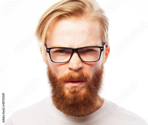 Young handsome redhair man with beard skeptic and nervous, disapproving expression on face.