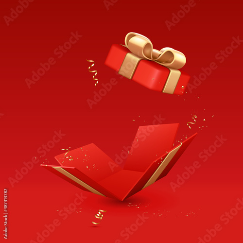 Red gift box with open lid with gold ribbons and bow, isolated on red background.