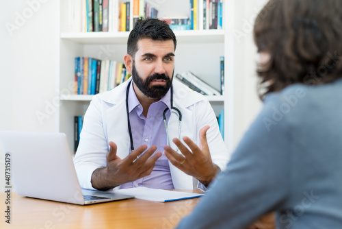 Mature doctor with hipster beard warning patient