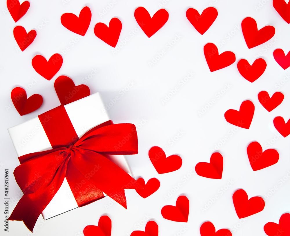 red paper hearts and gift box on white background. Valentine's Day. Love Concept background red paper hearts and gift box on white background. Valentine's Day. Love Concept background