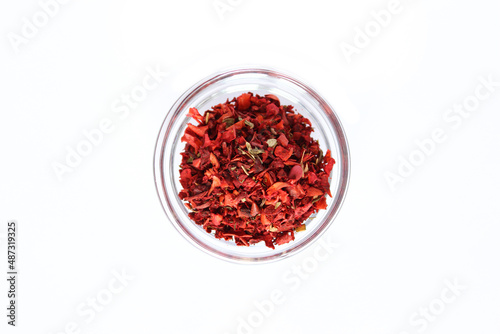 Series, spices on a white background, isolate, in different angles. Red, orange, bright pepper mix in a bowl