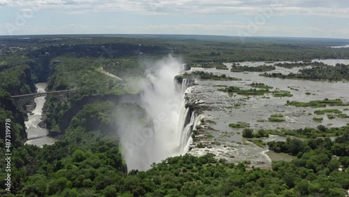 Aerial view of Victoria Zambia waterfall. A beautiful natural wonder where the Zambezi River forms a waterfall in the rocks in the savannah in the landscape. photo