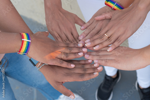 Group of hands together with LGTB handles