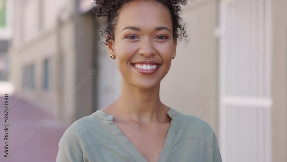 Smiling African girl smiling in city street Smiling African girl smiling in city street