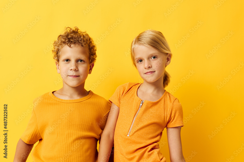 Cute stylish kids casual wear games fun together posing on colored background unaltered Cute stylish kids casual wear games fun together posing on colored background unaltered