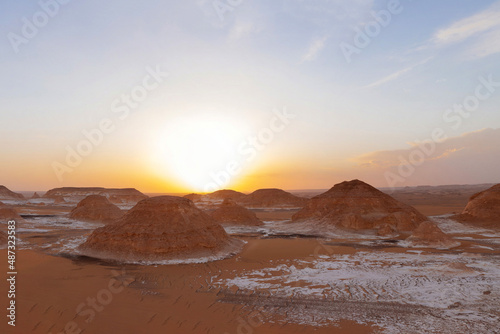 Attractive sunset in the Red Desert with ancient ruins.