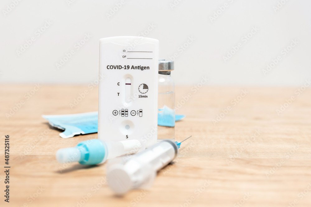 Rapid antigen test kit for viral disease COVID-19 with negative result on wooden table with copy space