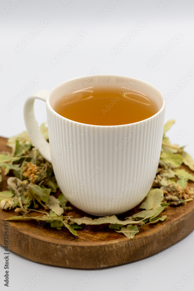 Winter Herbal tea isolated on a white background. Linden tea. immune-boosting herbal tea. Medicinal tea prepared from linden leaves, Clove particles and Chamomile. Winter Herbal tea isolated on a white background. Linden tea. immune-boosting herbal tea. Medicinal tea prepared from linden leaves, Clove particles and Chamomile.