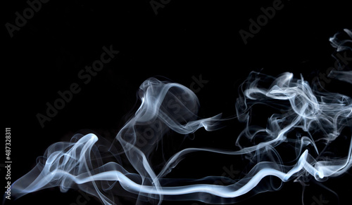 Twisted plumes of smoke, smoke movement on a black background. Abstract smoke lines