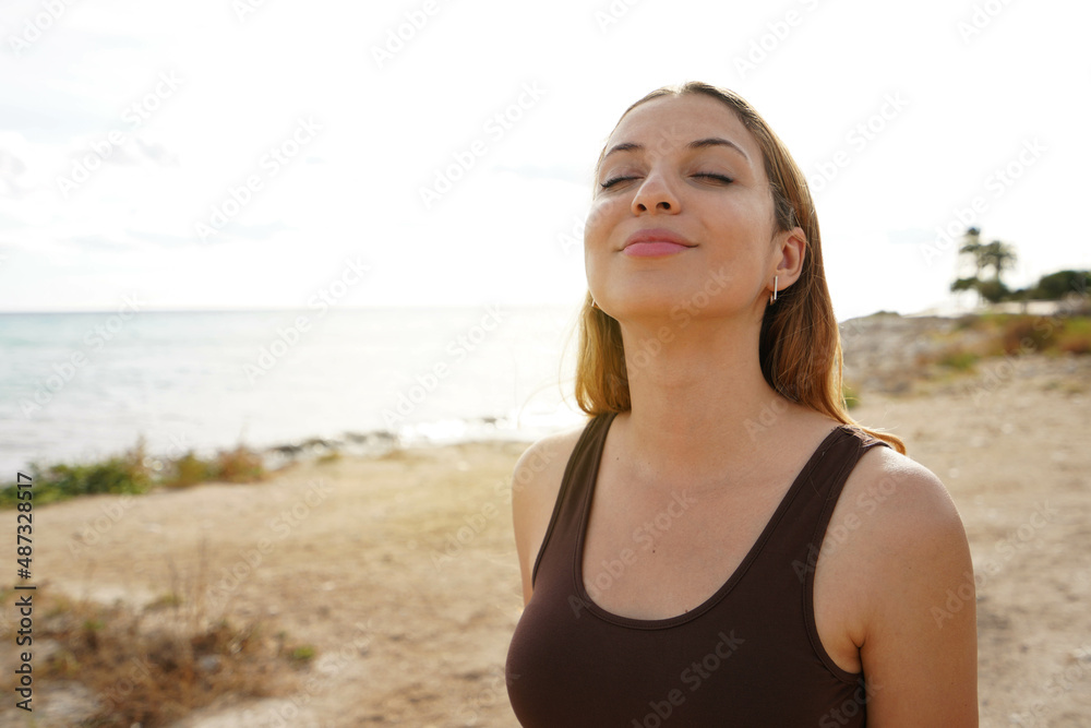 Relaxed beauty breathing girl with closed eyes on the beach. Copy space Relaxed beauty breathing girl with closed eyes on the beach. Copy space