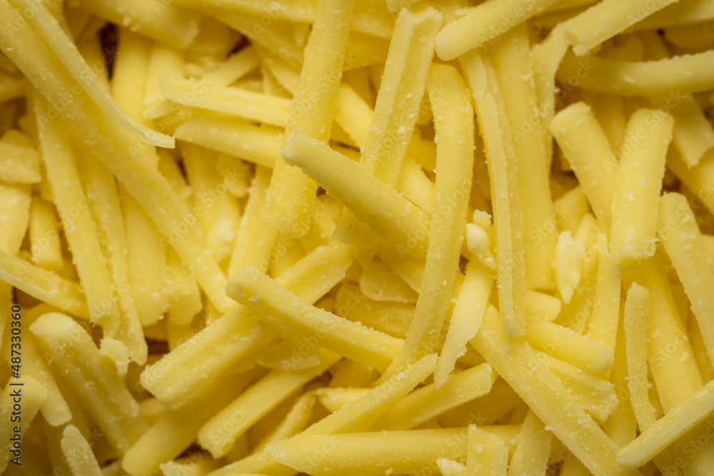 grated cheddar cheese background closeup grated cheddar cheese background closeup